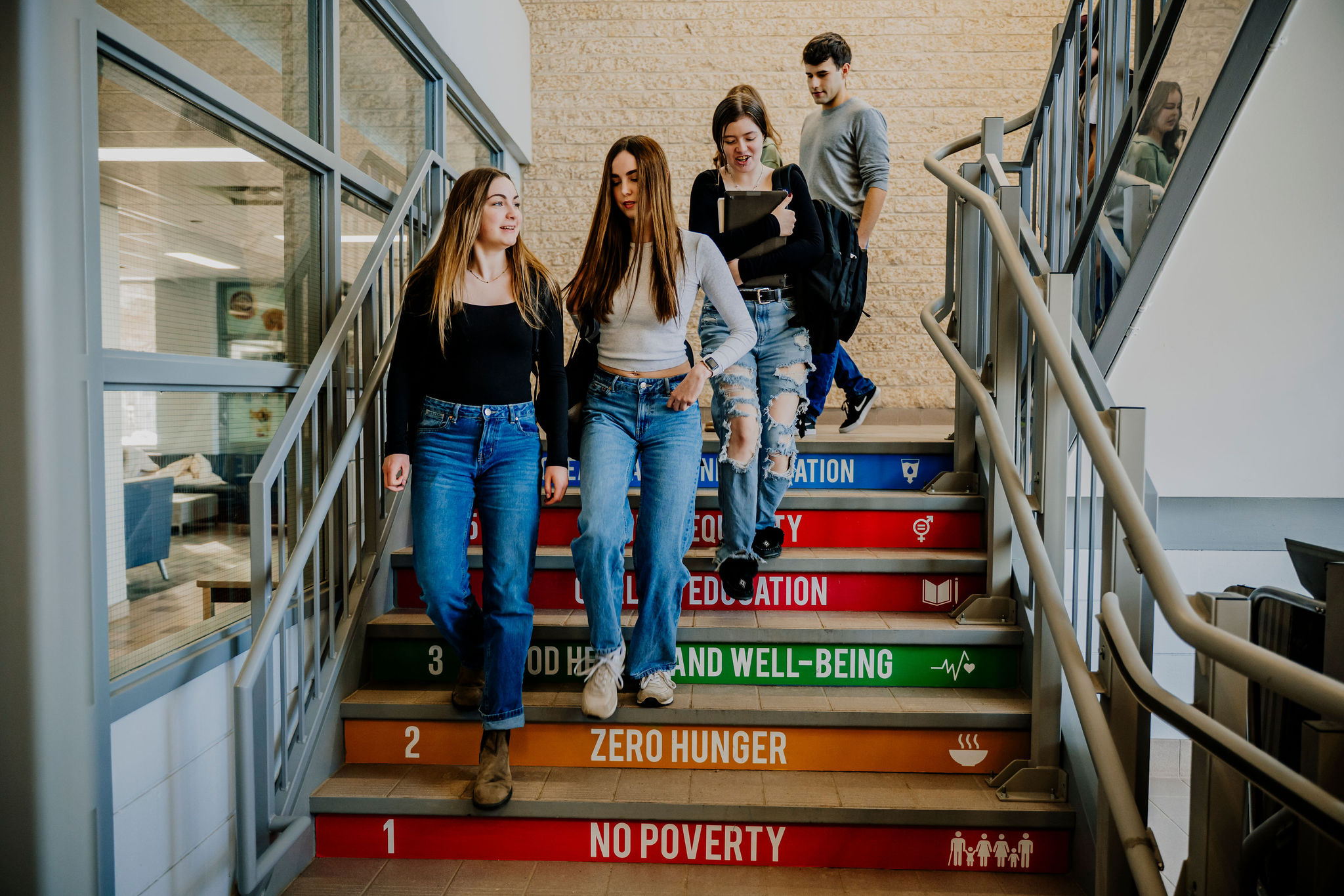 Students walking down stairs with our UN sustainability goals